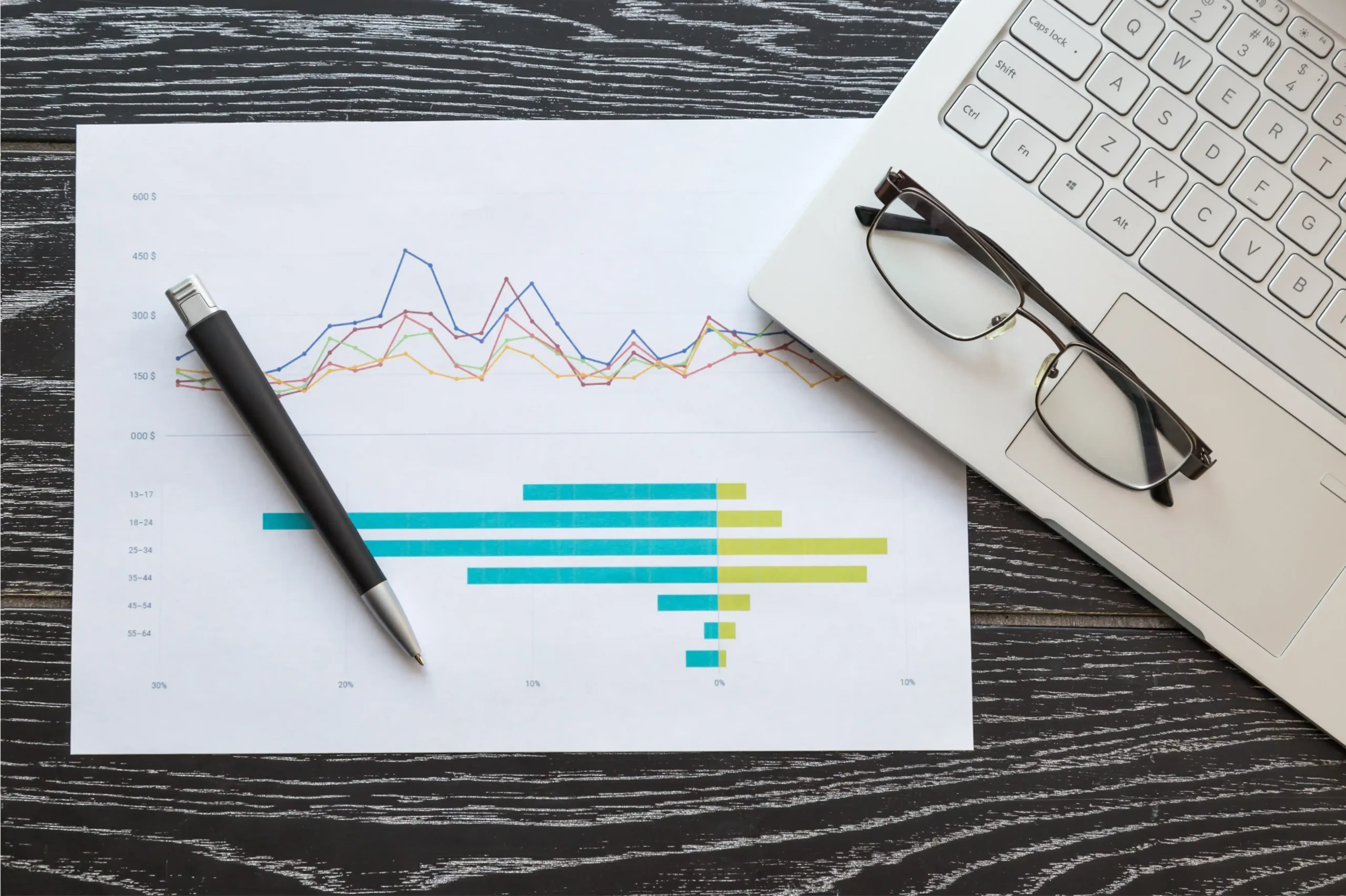 top-view-of-laptop-and-paper-with-graphs-and-diagr-2025-03-07-13-51-08-utc