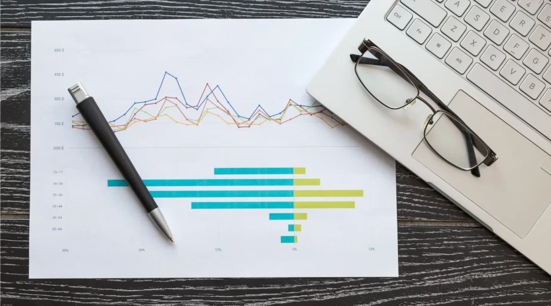top-view-of-laptop-and-paper-with-graphs-and-diagr-2025-03-07-13-51-08-utc
